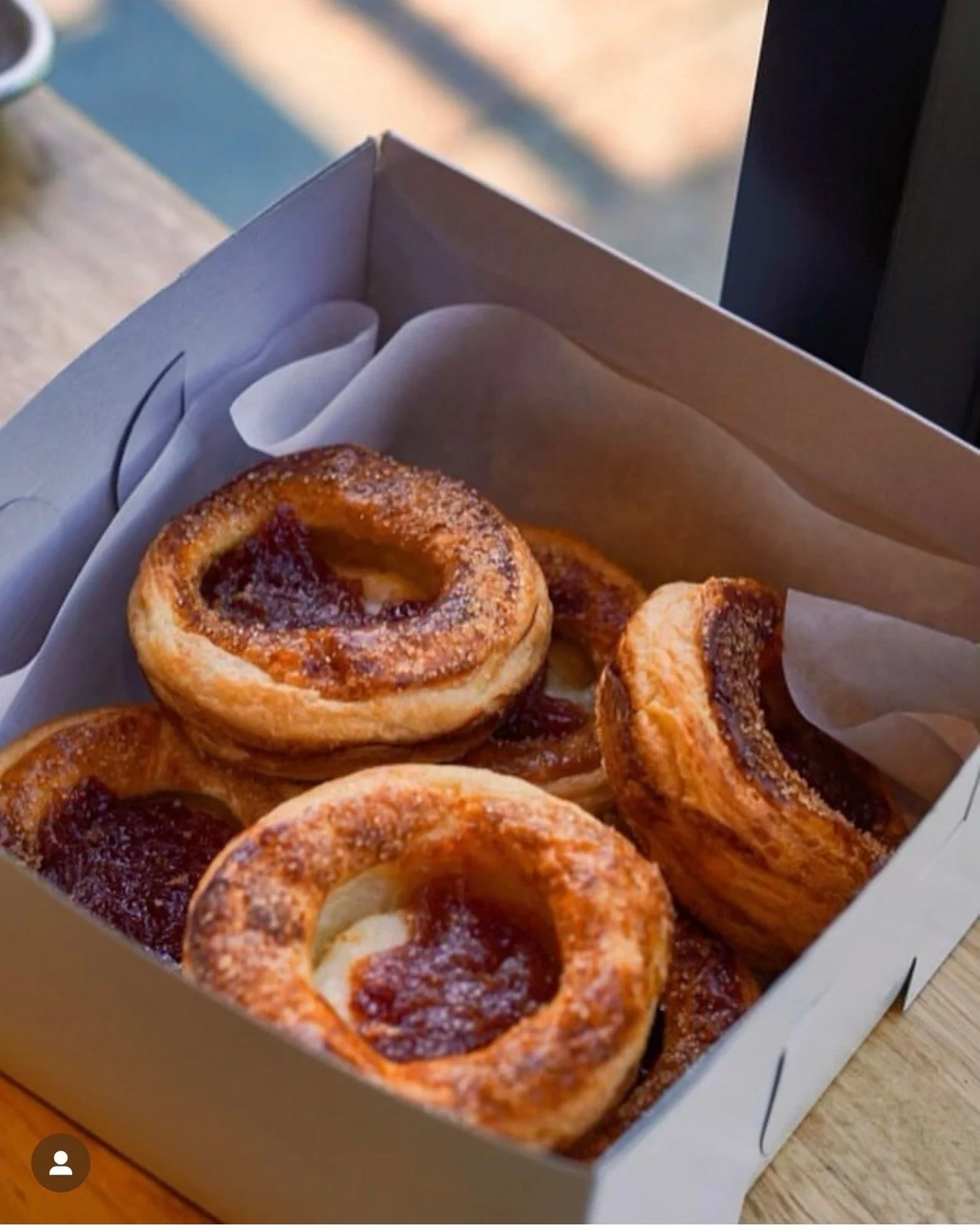 Round pastries packed in a bakery box