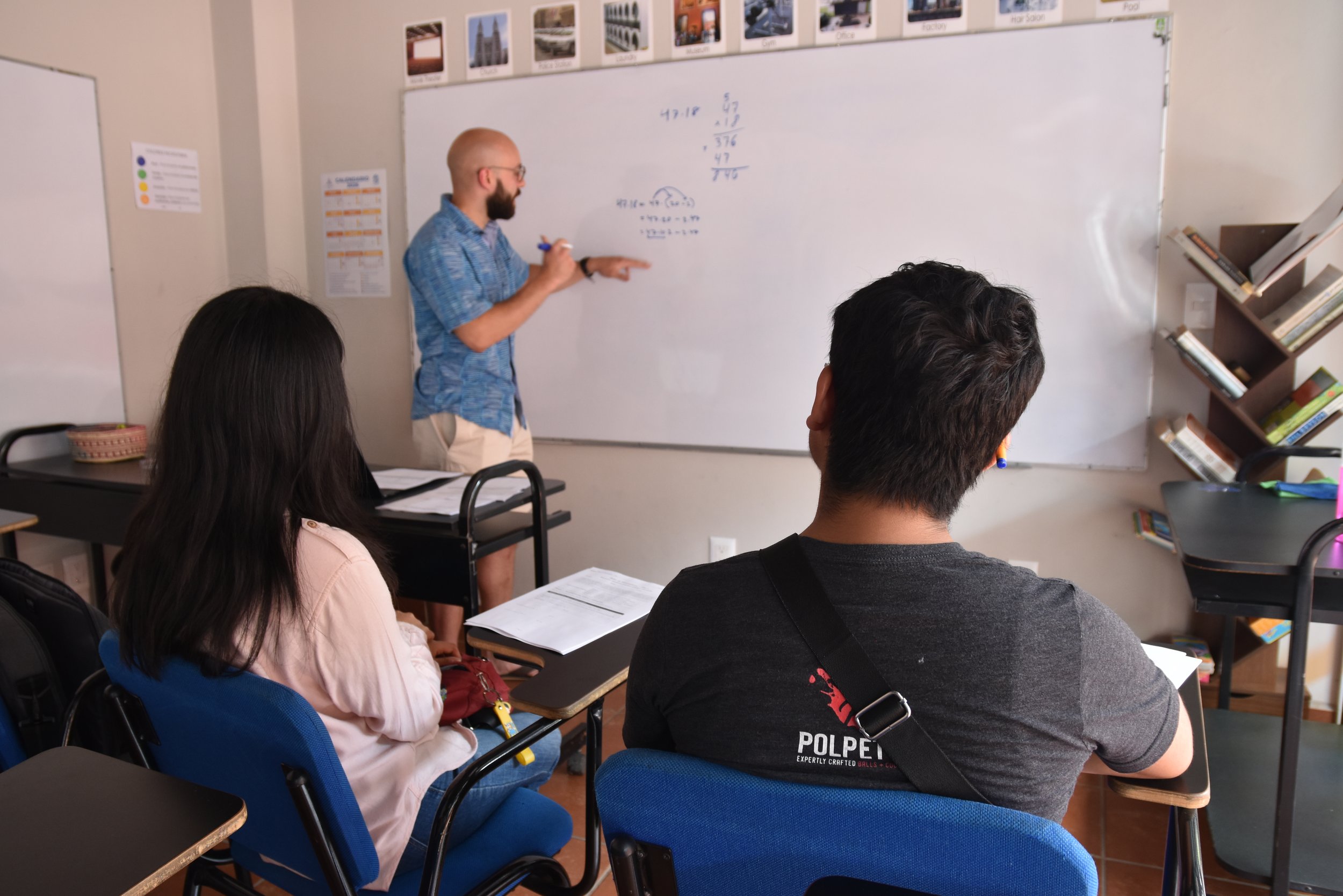 Volunteer working with students