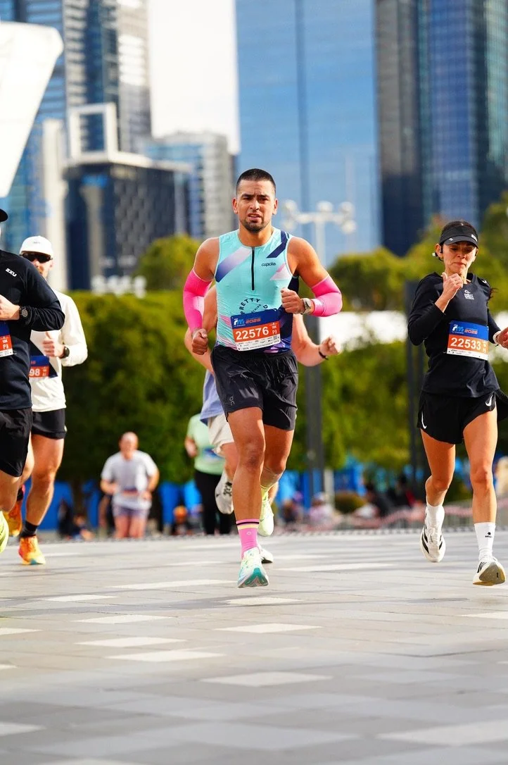 A man in Pretty Strong kit at the finish