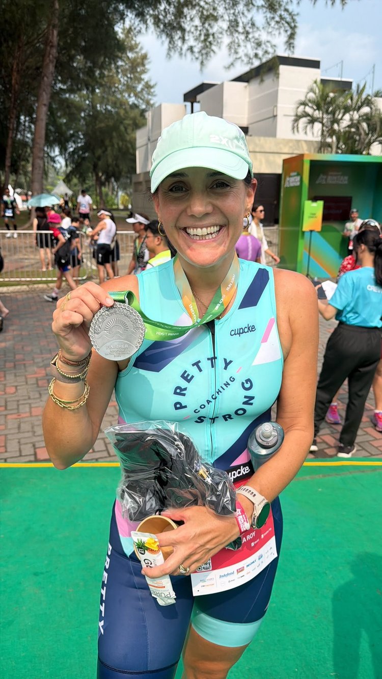 A Pretty Strong athlete with her medal after the Bintan Triathlon