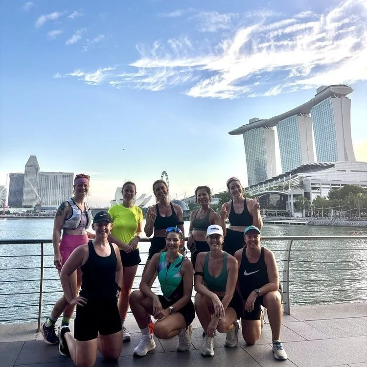 Nine Pretty Strong athletes together on the Marina Bay waterfront after a morning run