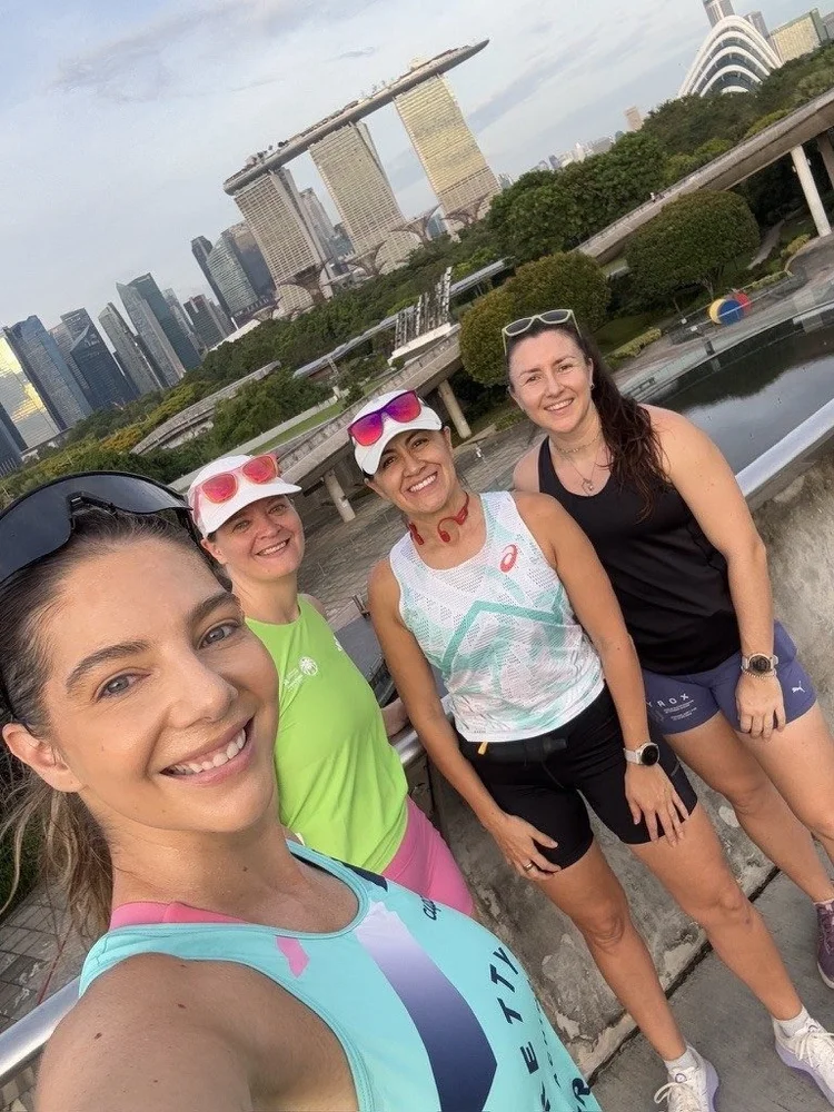 Frankie and three Pretty Strong athletes at Gardens by the Bay with the Singapore skyline behind