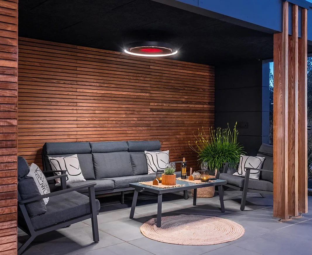 Eclipse electric heater with a glowing LED ring above outdoor seating