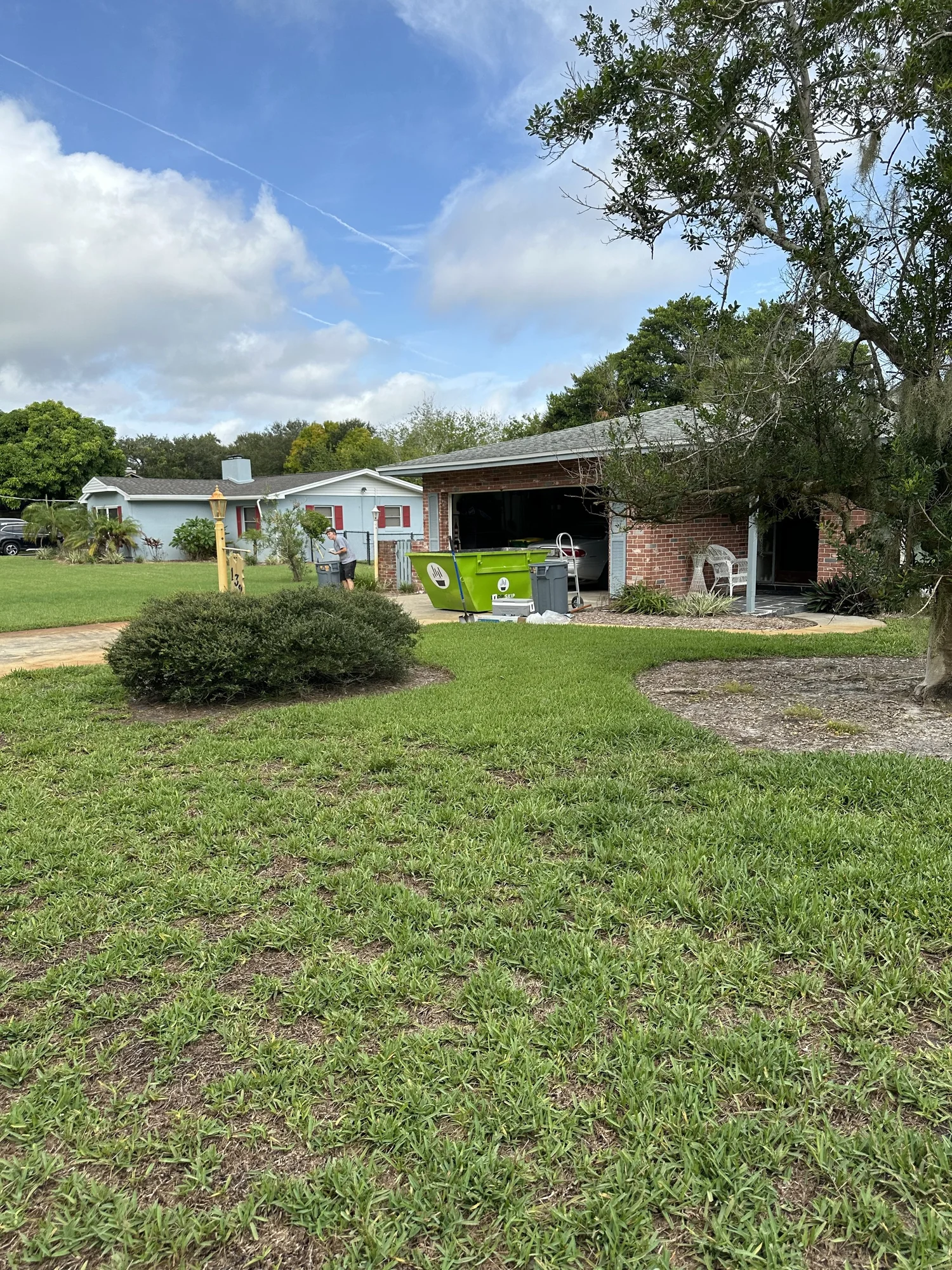 Compact 3-yard Skip Mini mini dumpster at a residential home in Brevard County, FL