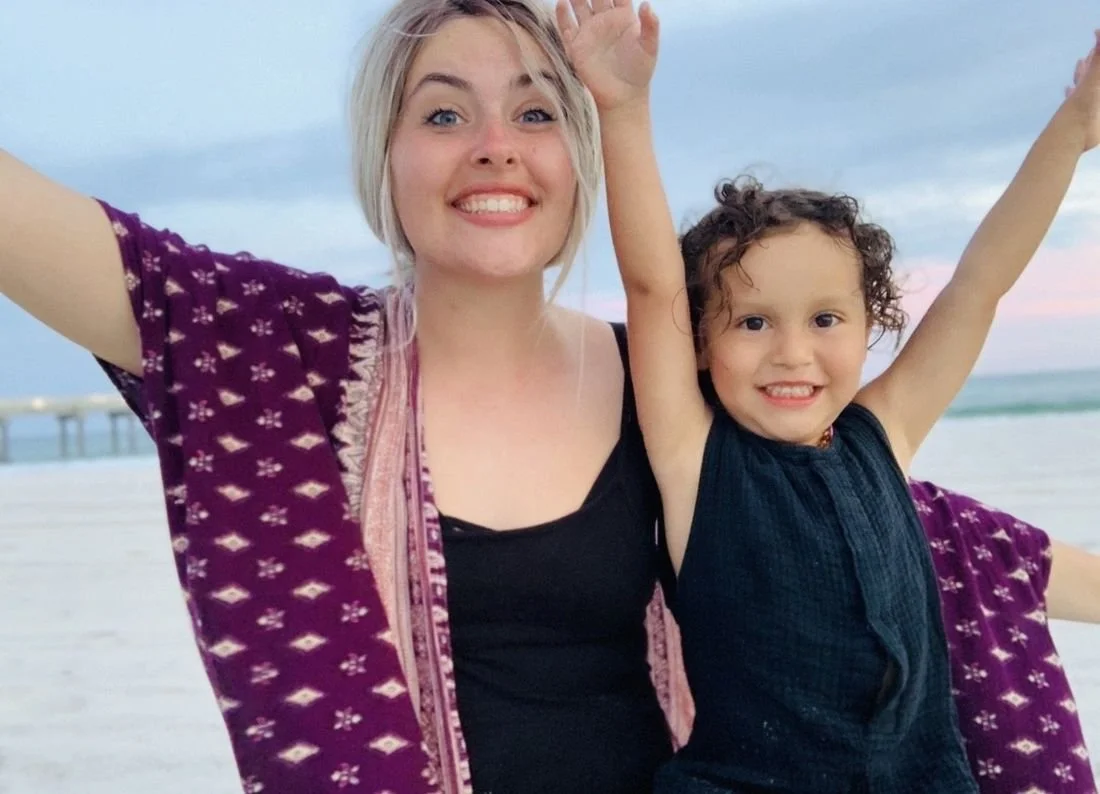 Elizabeth and her son cheering on the beach