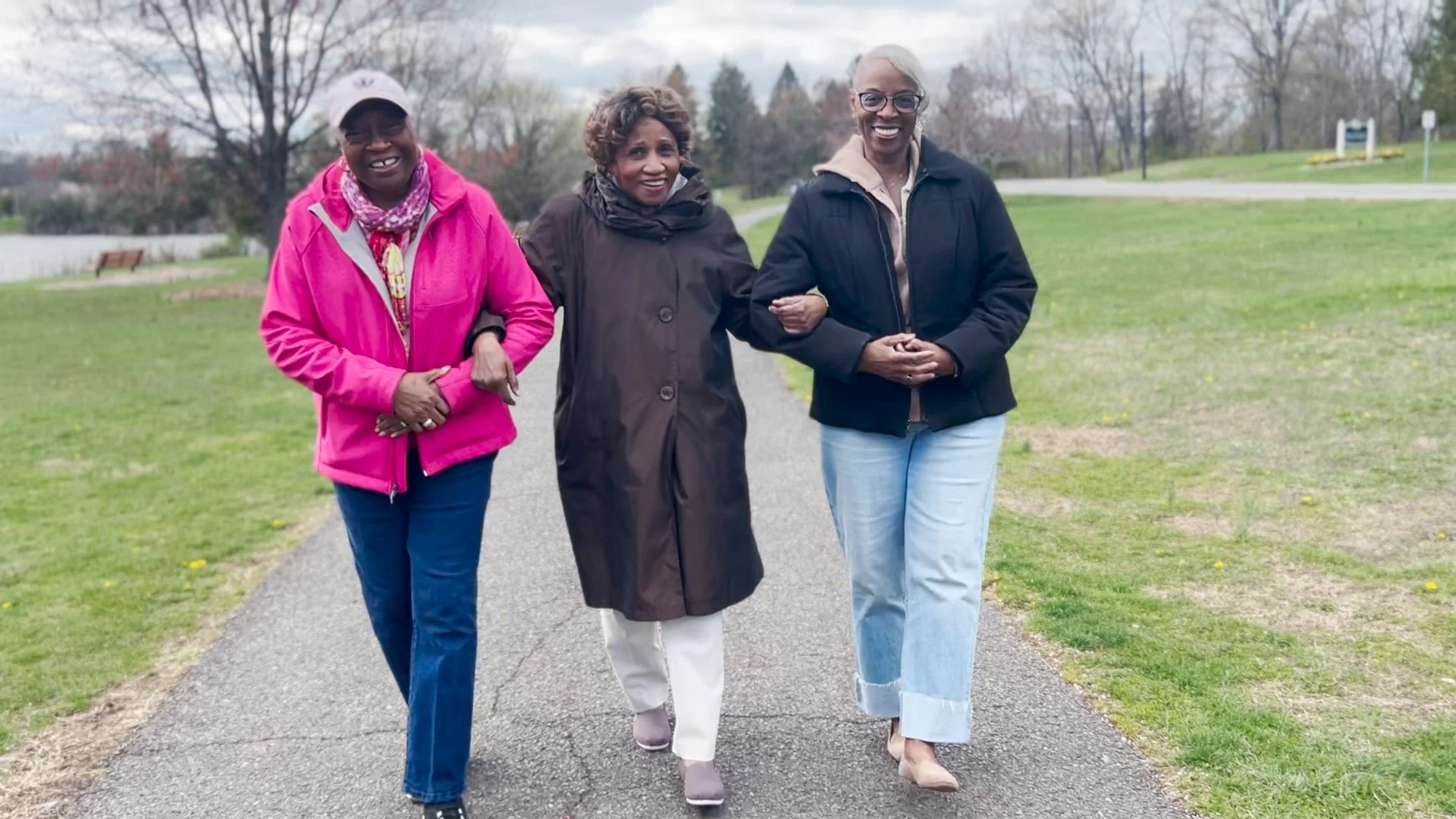 Rosa Davis, Dorothy J. Reed, and Lareatha Payne walking together through Colonial Park
