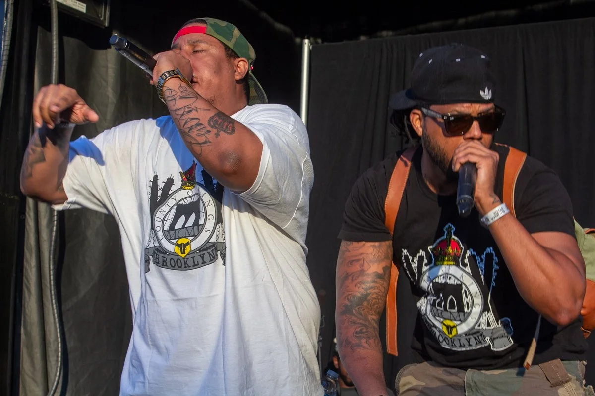 Pumpkinhead delivers an animated live performance onstage as LR Blitzkrieg joins him on the microphone during a hip-hop concert.