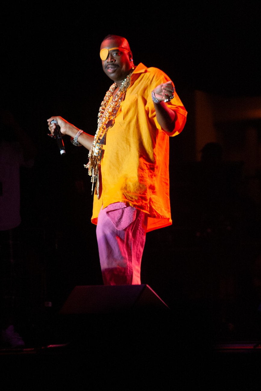 Slick Rick performing at Wingate Field in orange and pink stagewear