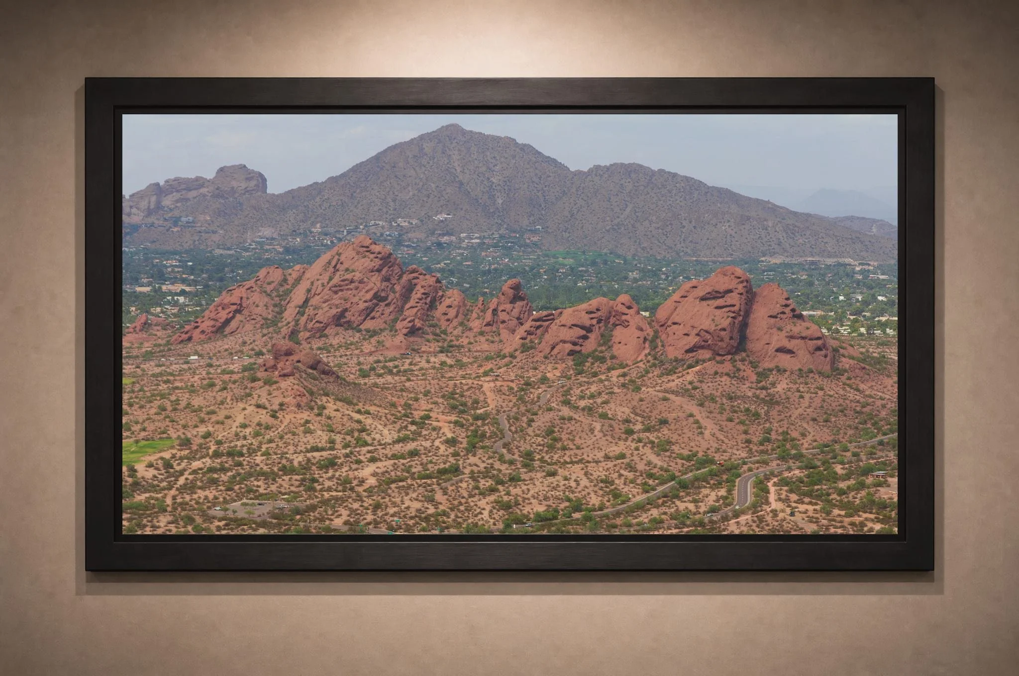 Ancient Earth, Eternal Sky fine-art print of the Papago Buttes and Camelback Mountain displayed on an interior wall
