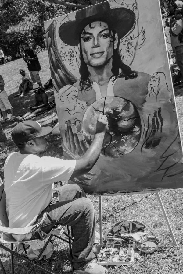 Artist painting a Michael Jackson tribute during BK Loves MJ