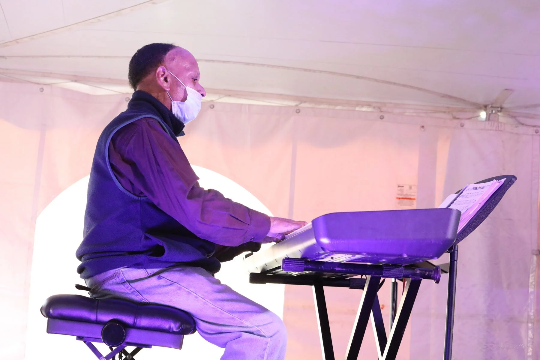 Ptah Williams seated at a piano during a live jazz performance in St. Louis