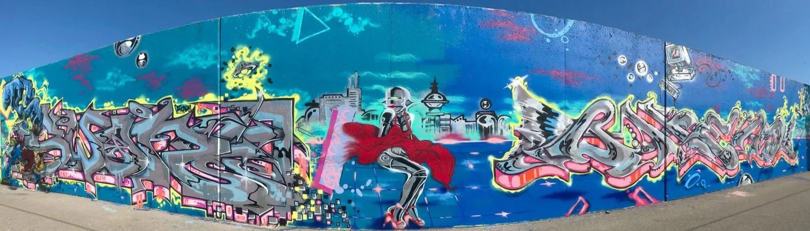 Blue Mural Mile production combining graffiti lettering, futuristic imagery and illustrated figures