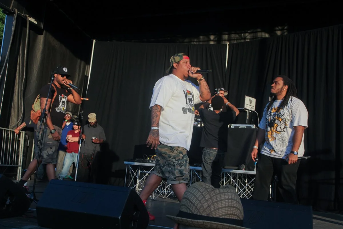 Wide shot of Pumpkinhead and LR Blitzkrieg performing live together during a hip-hop concert.