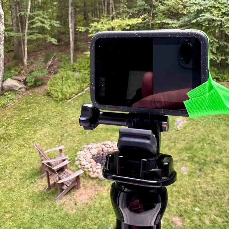 Timelapse camera set up on a window overlooking a wooded backyard in Rhode Island