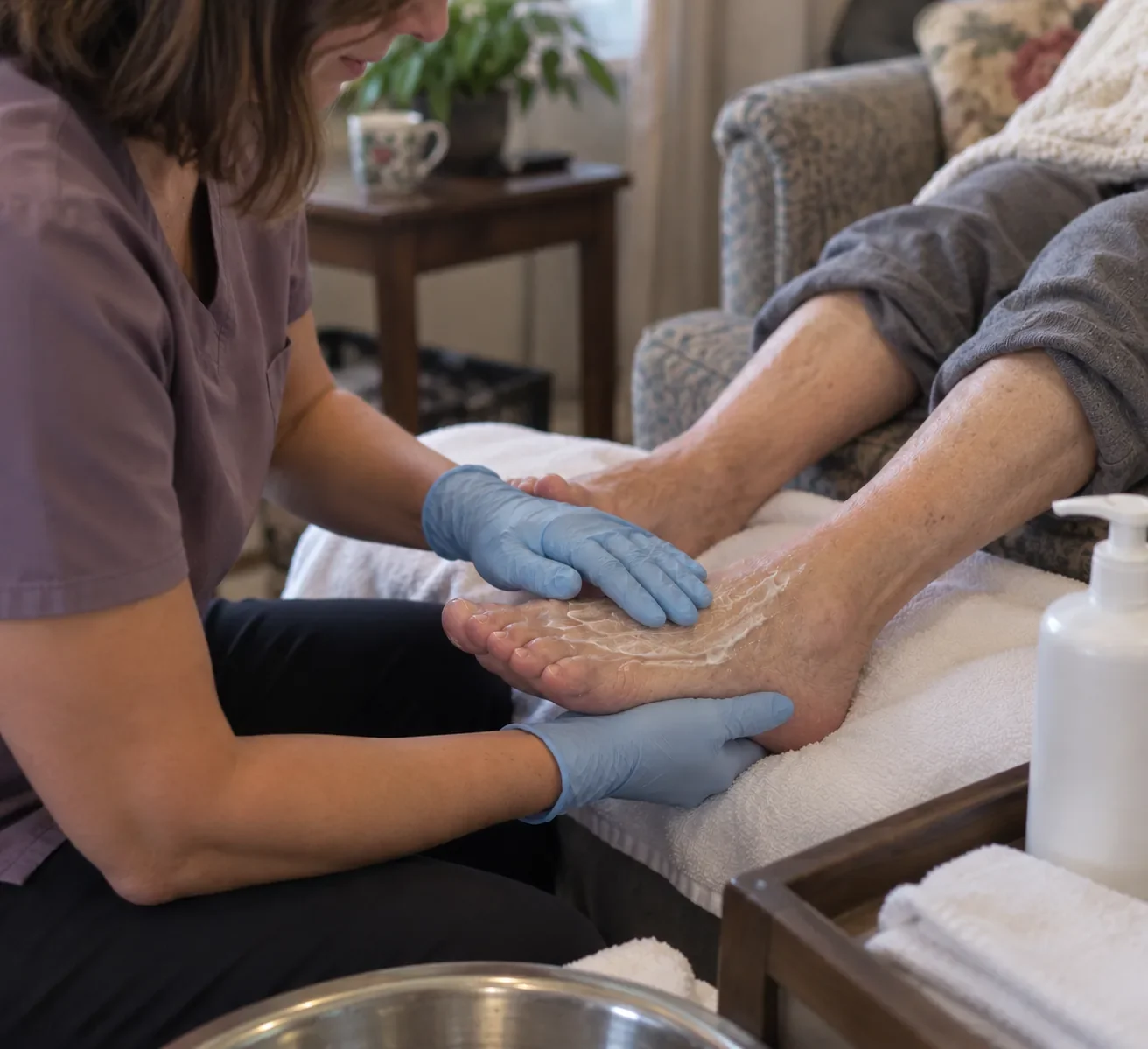 Foot care nurse applying moisturizer and gently massaging a senior's feet