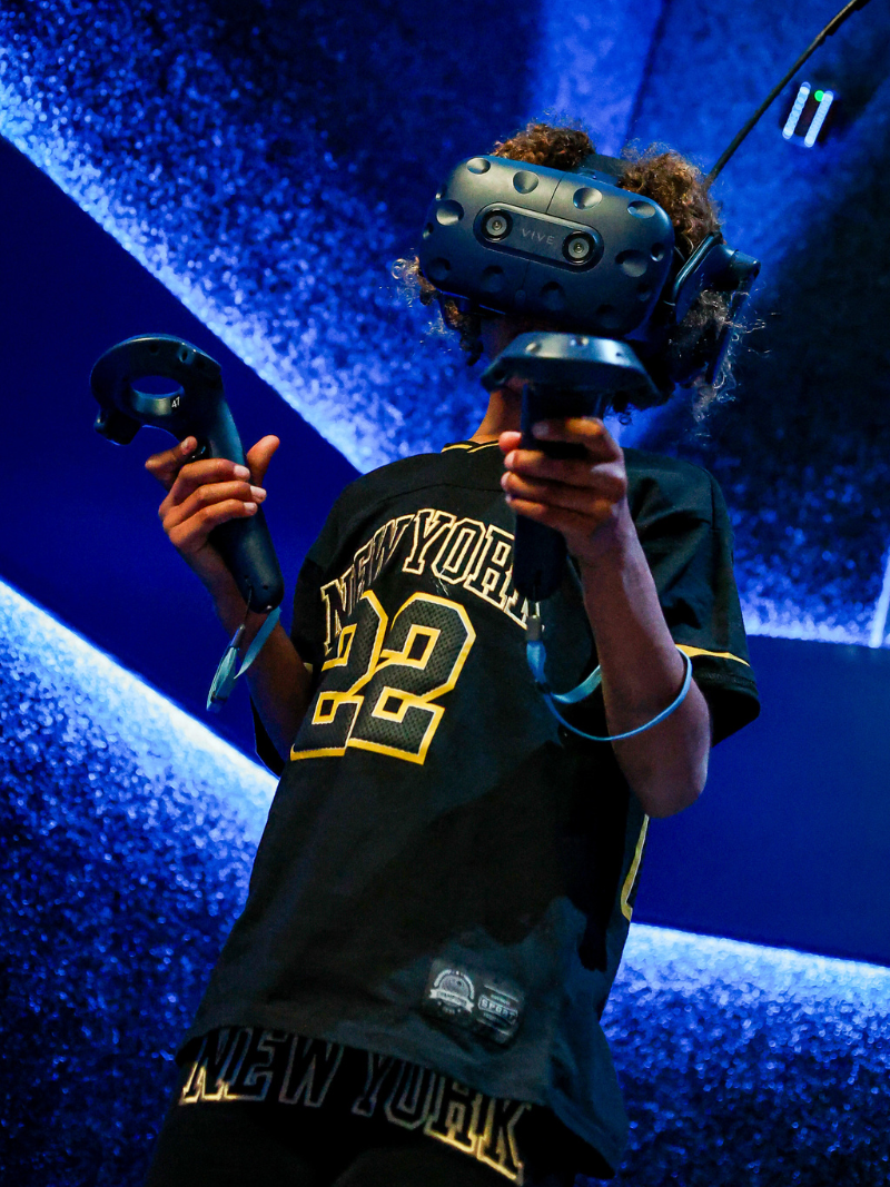Person wearing a VR headset immersed in a fantasy battle scene