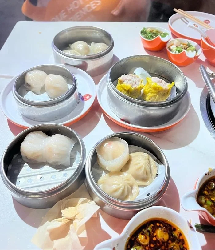 Bamboo and metal steamer baskets of fresh dim sum on the table