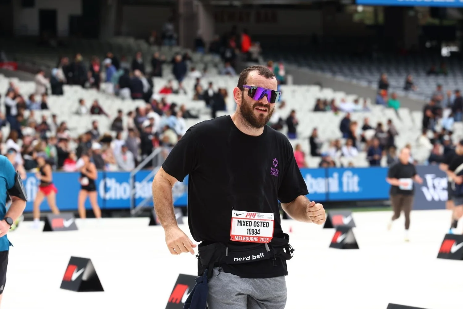 Dr Luke Smith of Mixed Osteo running into the MCG at the 2025 Melbourne Marathon