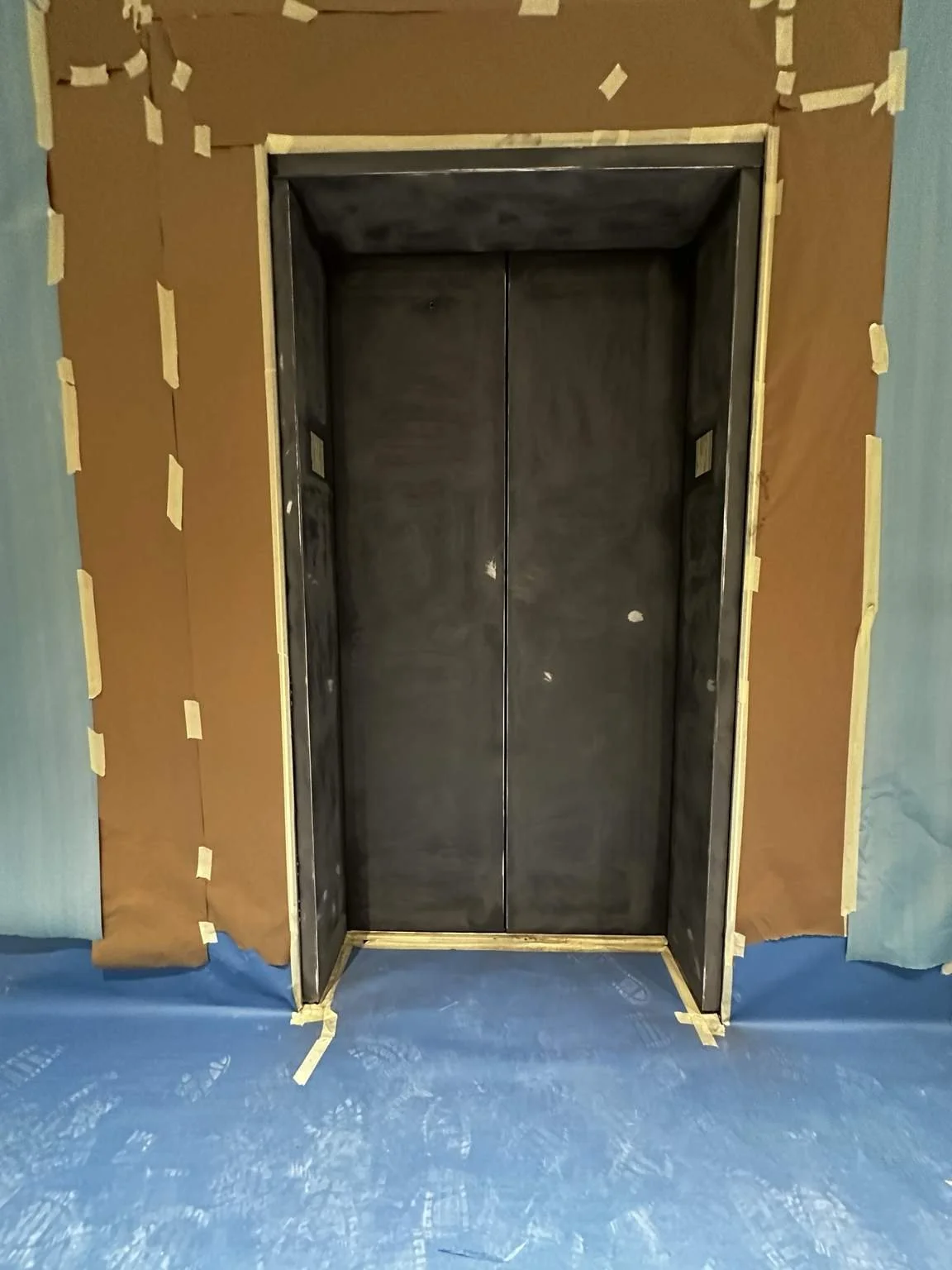 Elevator door before HVLP spray painting by Eagle Crest Painting