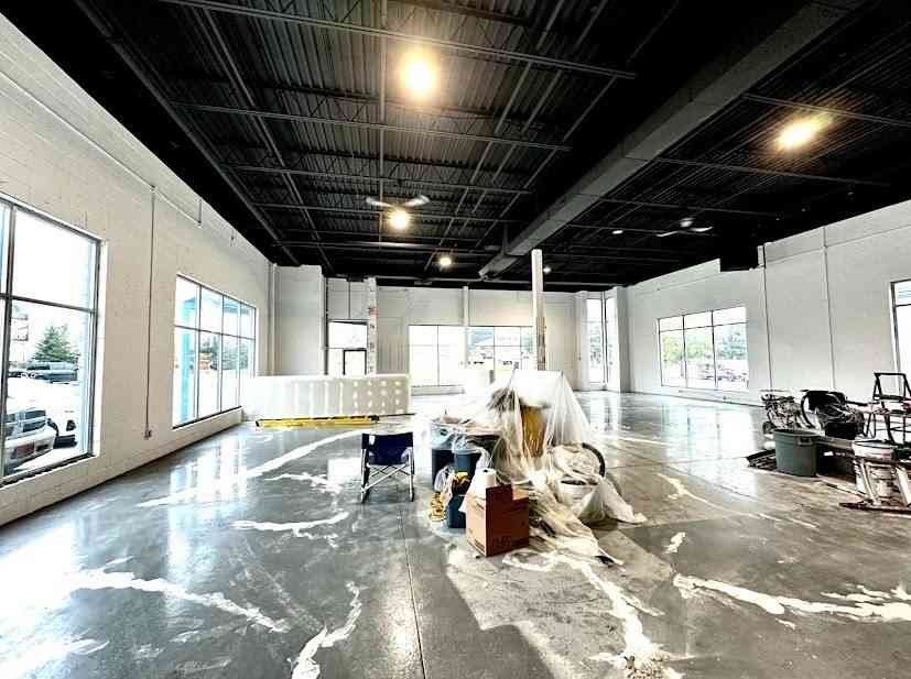 Eagle Crest painter using professional airless spray equipment on a large commercial surface