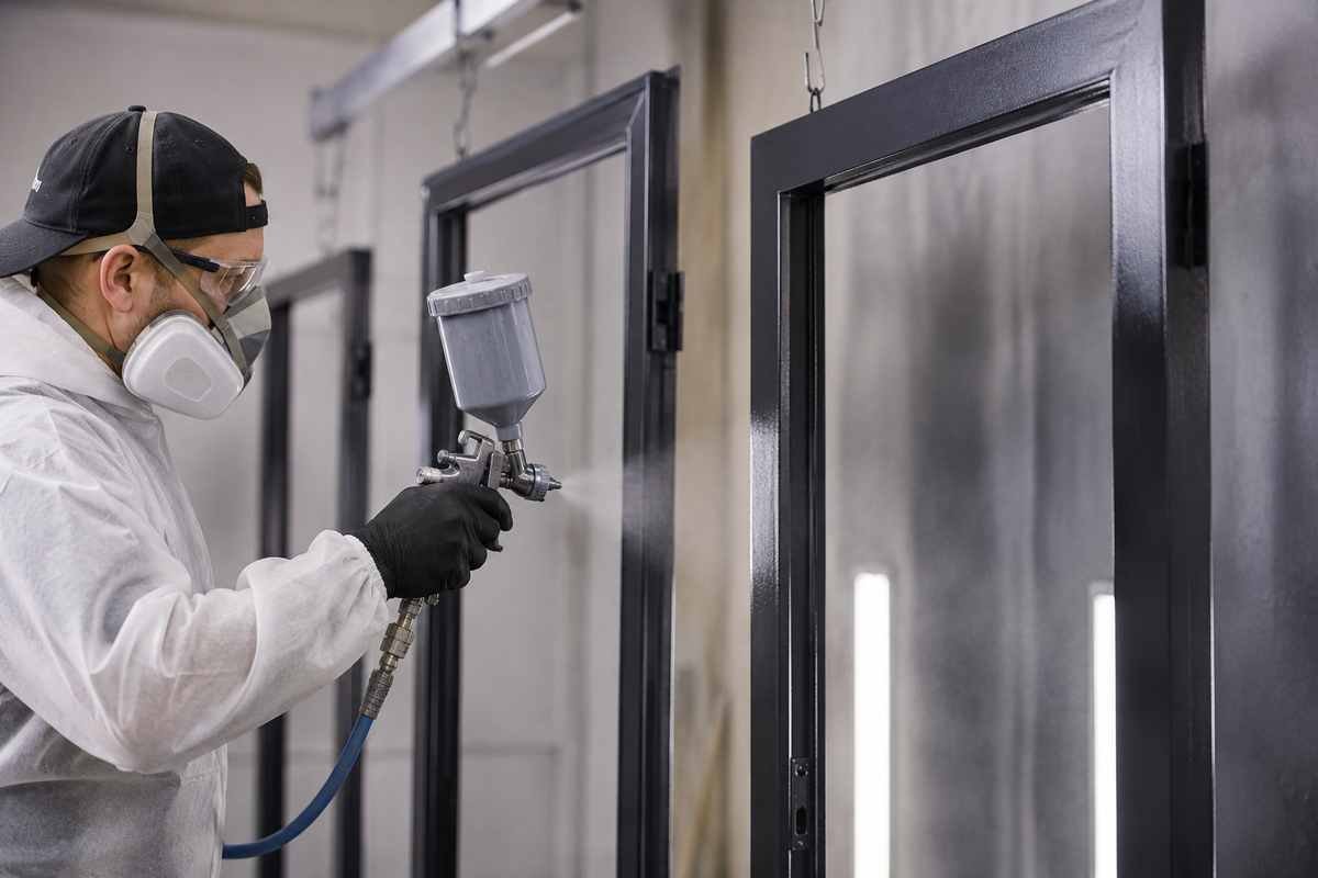 HVLP spray finishing metal door frames for a commercial property in Simcoe County Ontario