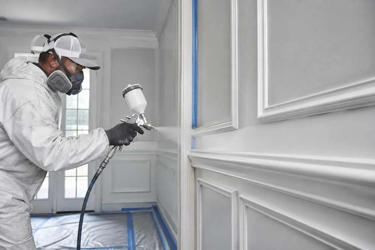 HVLP spray painting architectural trim for a commercial interior in Ontario