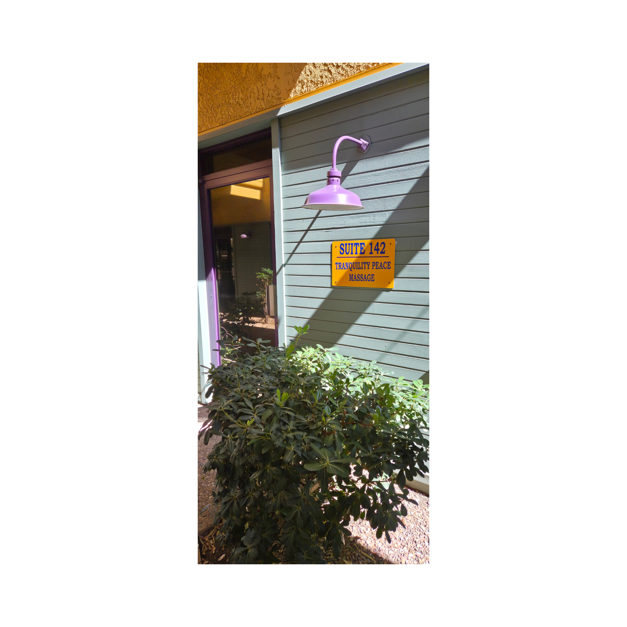 Yellow Suite 142 sign and purple entrance light at Tranquility Peace Massage