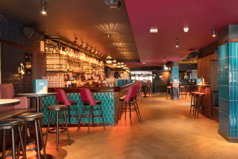 The cocktail bar and seating at Be At One.