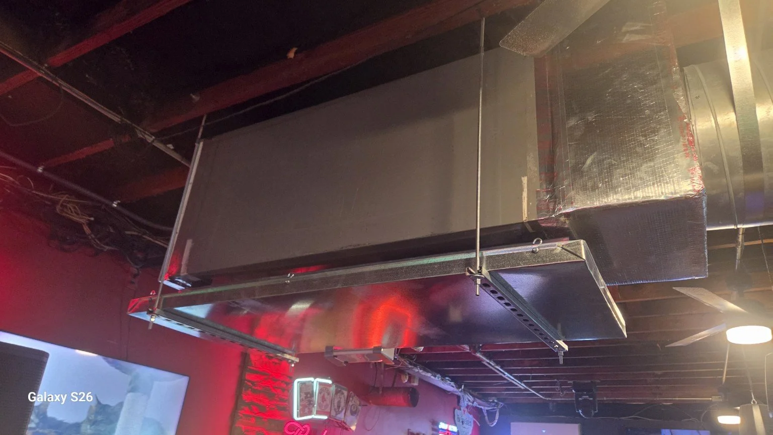 Support rods and drain pan beneath a ceiling-mounted air handler