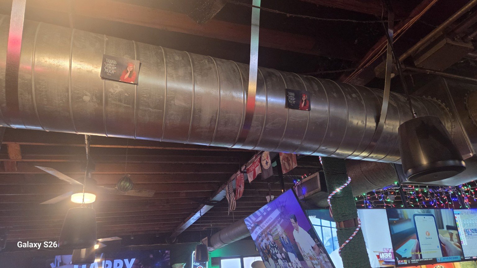 Exposed spiral AC ductwork inside the bar