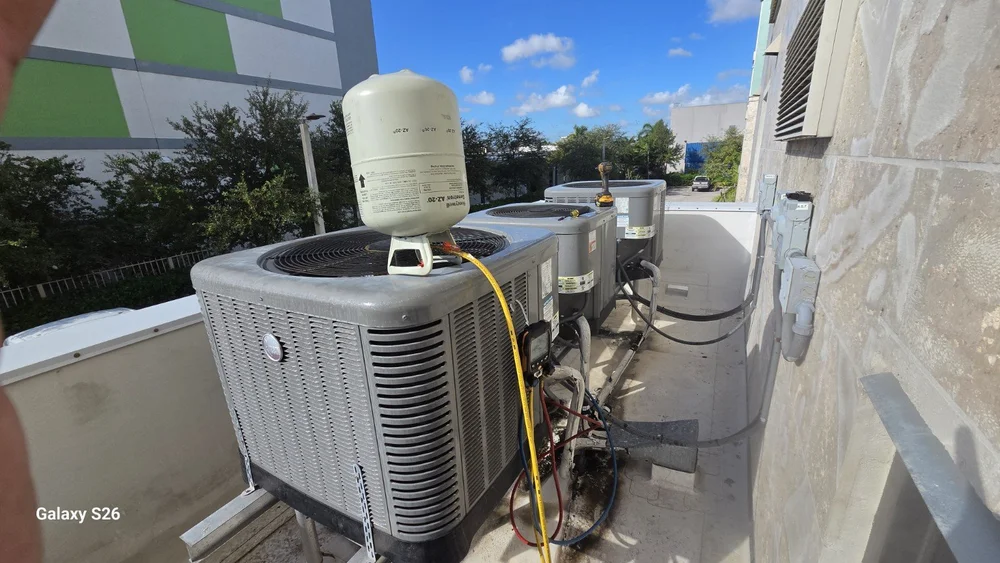 Refrigerant cylinder and service hoses during AC recharge at a Doral hotel