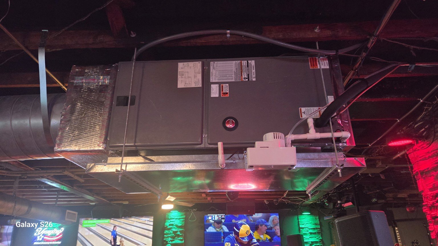 Ceiling-mounted air handler with drain pan and condensate piping at our Wilton Manors installation