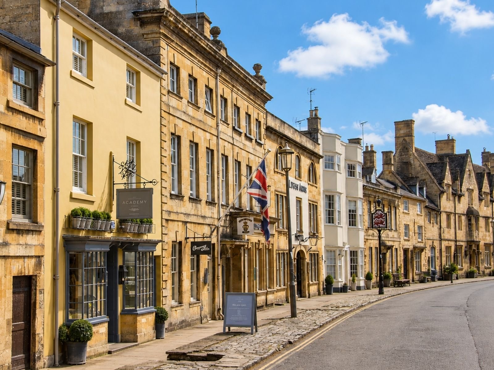 View along Chipping Campden High Street featuring historic golden Cotswold stone architecture