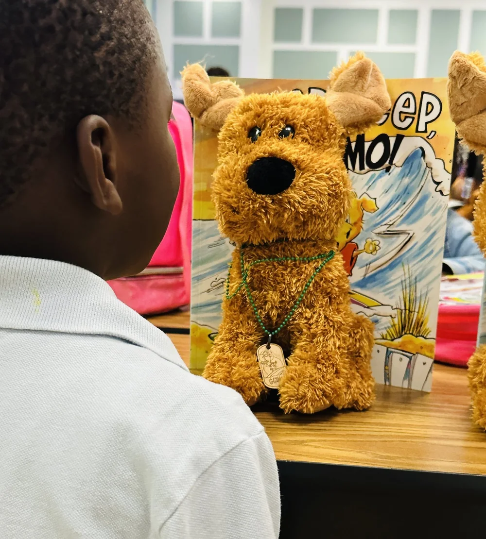 A student meeting a Gizmo plush up close
