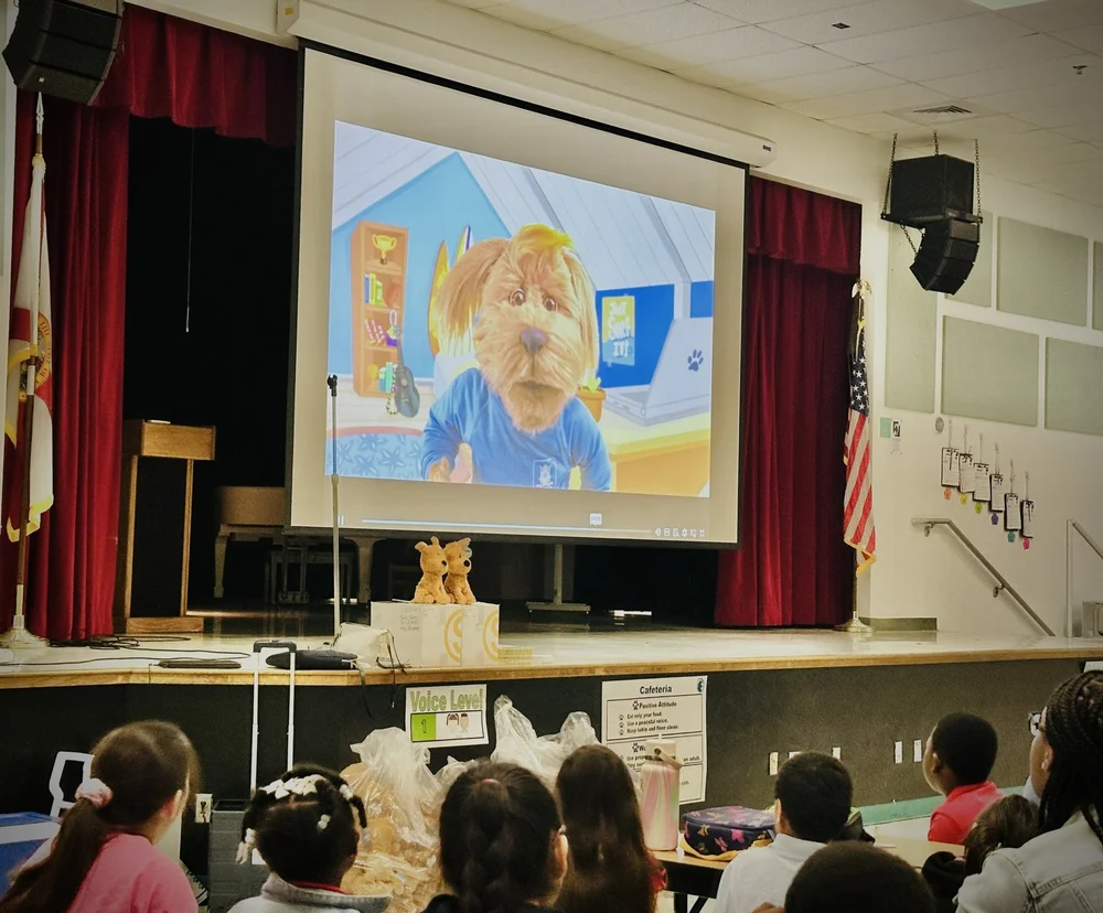 Gizmo on the big screen at a school assembly