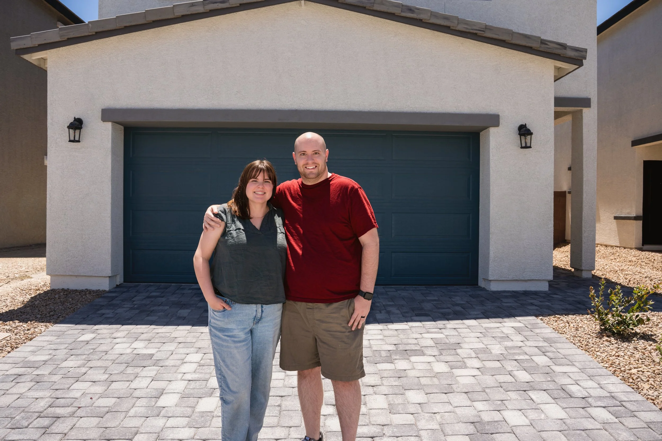 Couple standing in the driveway of their newly built North Las Vegas home.