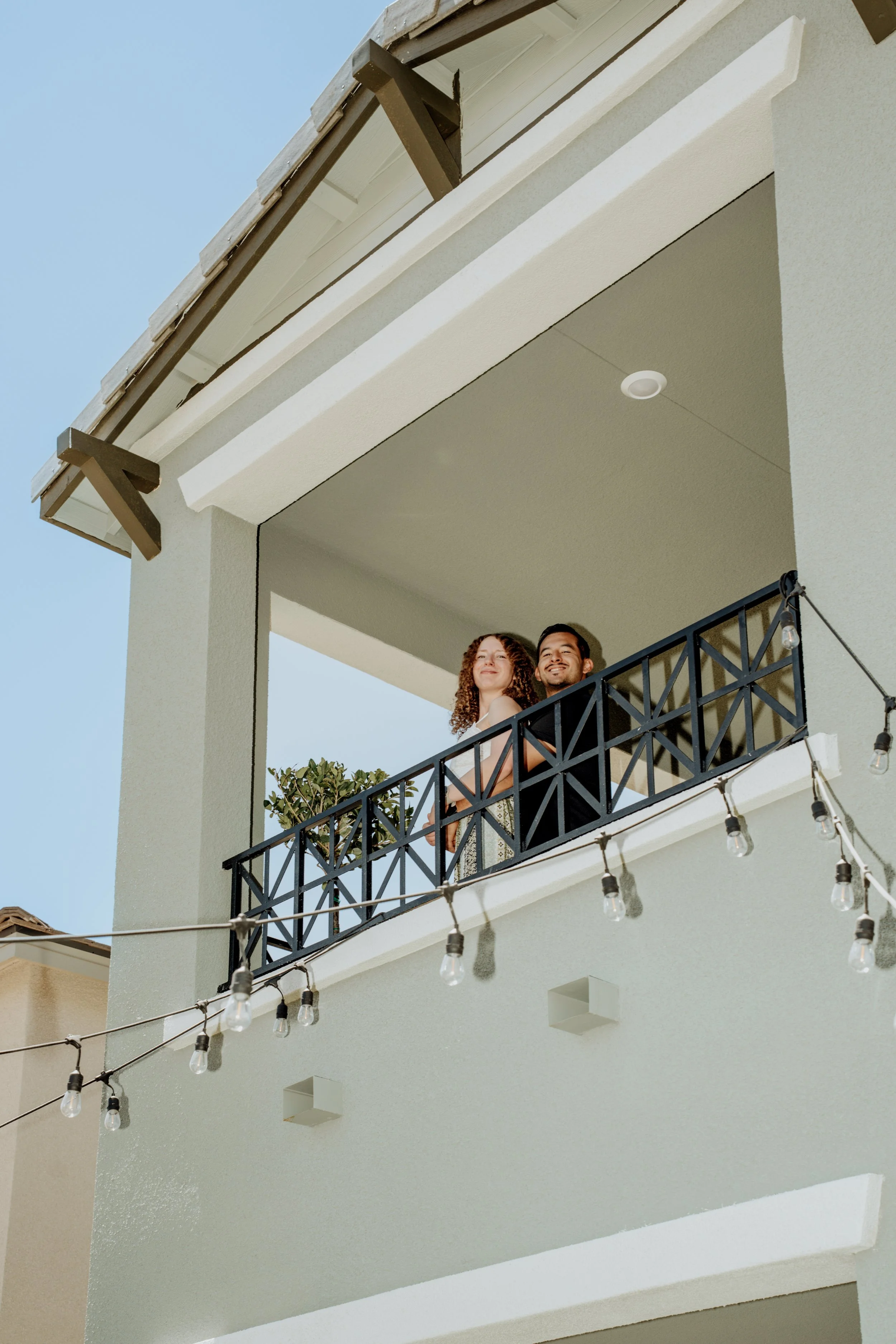 Couple standing on the upstairs balcony of their new Summerlin home.