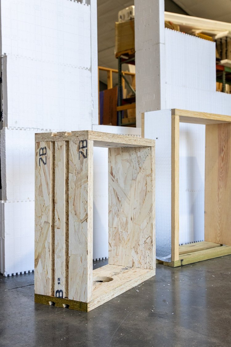 Prebuck window frame made of engineered wood panels standing beside stacked ICF blocks