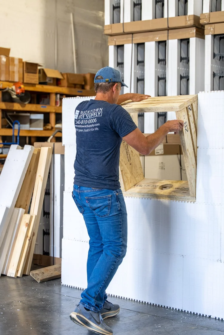 Installer setting a prebuck window frame into an ICF wall