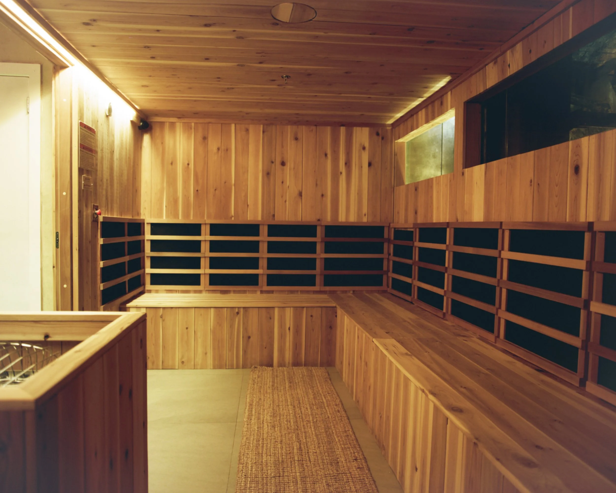 Wood-lined sauna with benches at Lore Bathing Club.