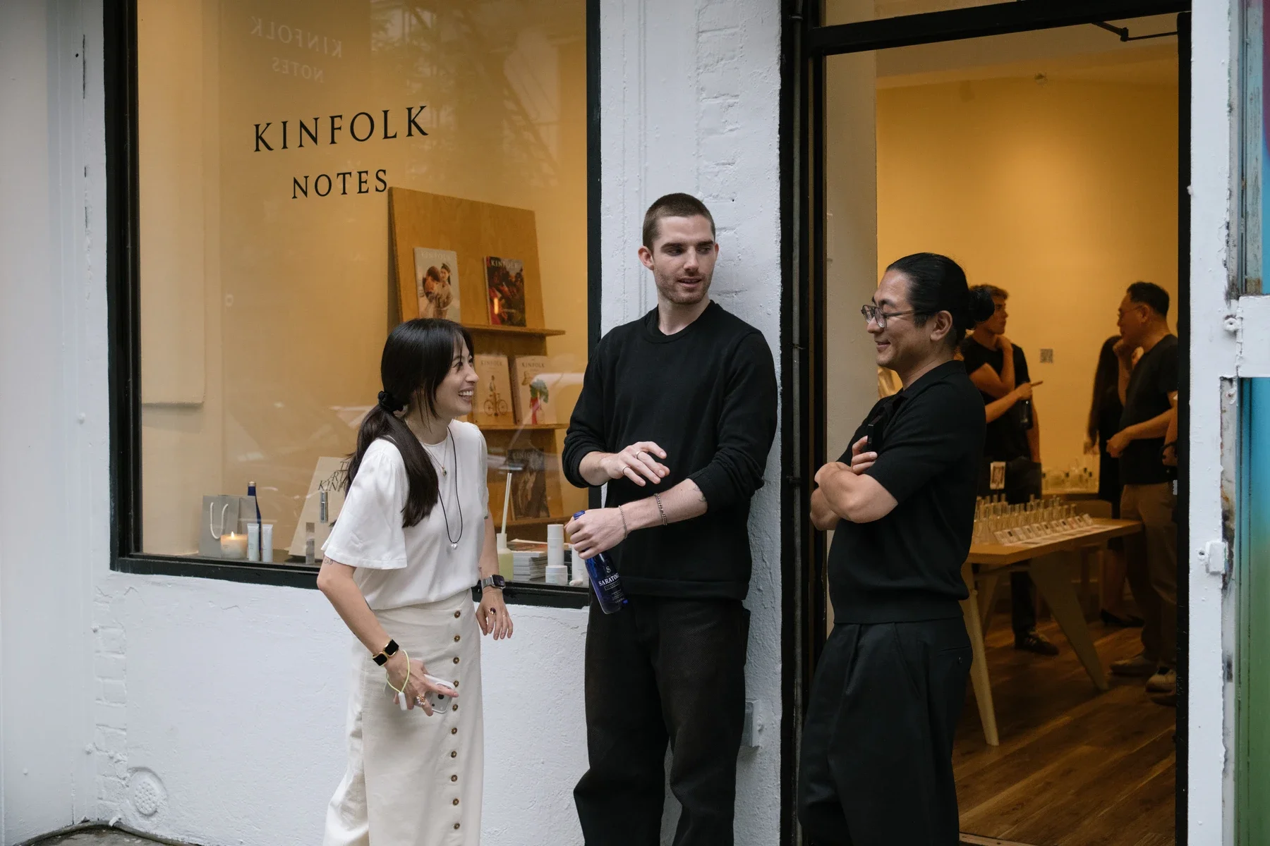 Three guests in conversation outside the Kinfolk Notes storefront on Elizabeth Street.
