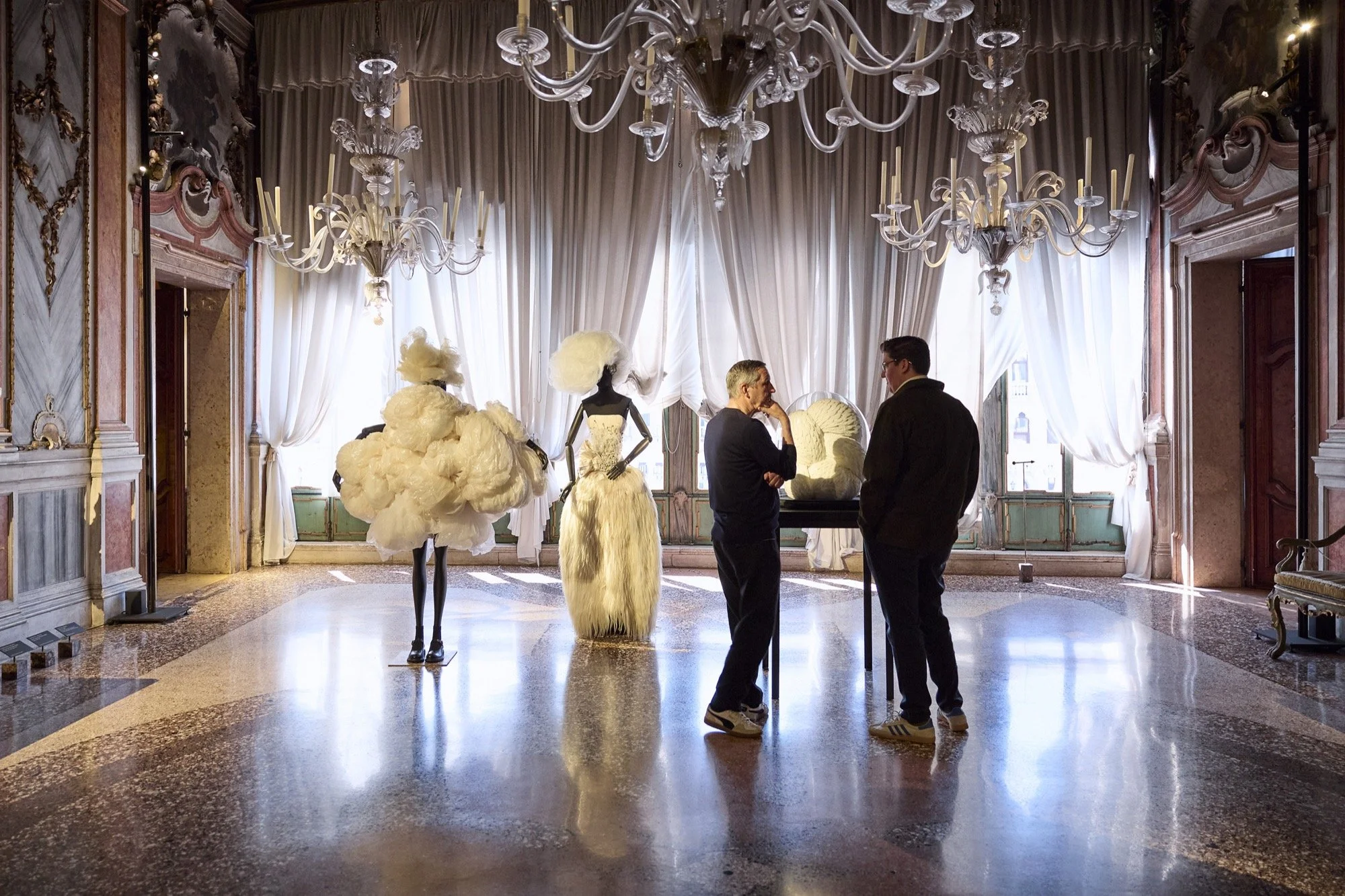 Dries Van Noten and Spencer Bailey inside an exhibition space at the Fondazione Dries Van Noten in Venice.