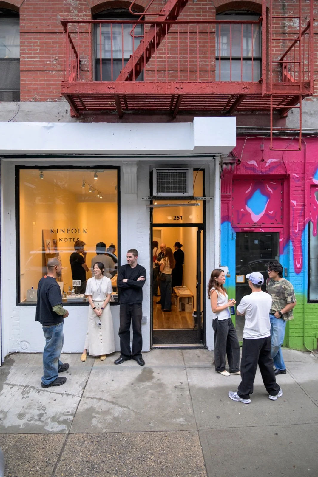 People in conversation outside the Kinfolk Notes pop-up on Elizabeth Street in New York.