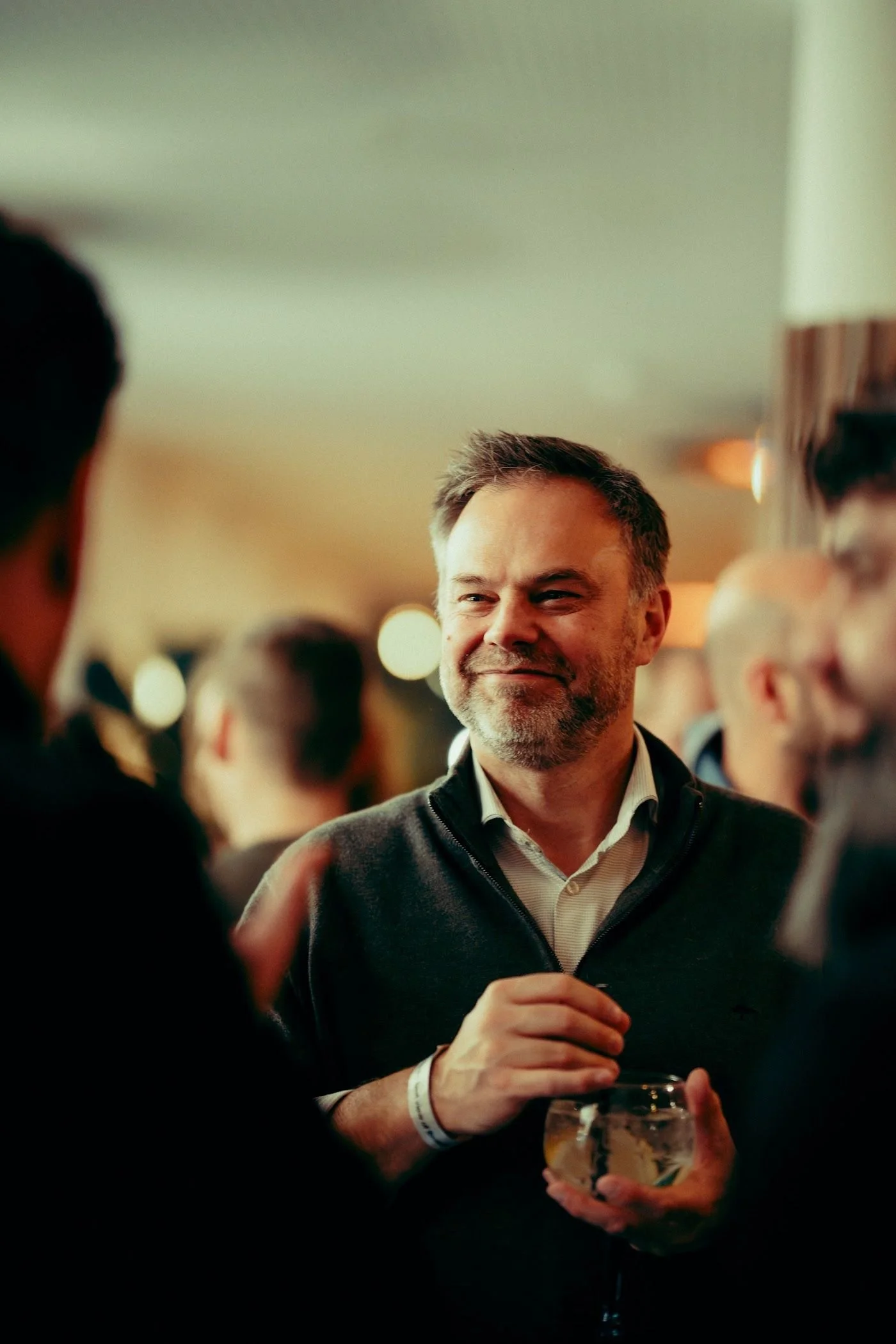 A guest smiling during an evening at the Penthouse