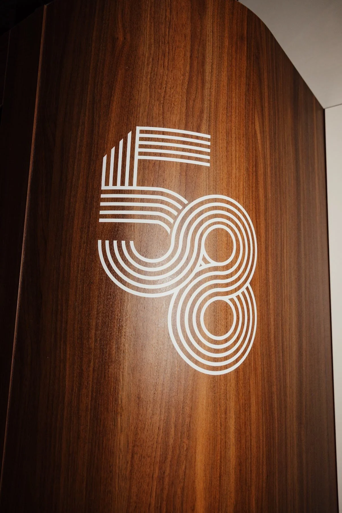 The 58 logo carved into wood, a detail of the bar