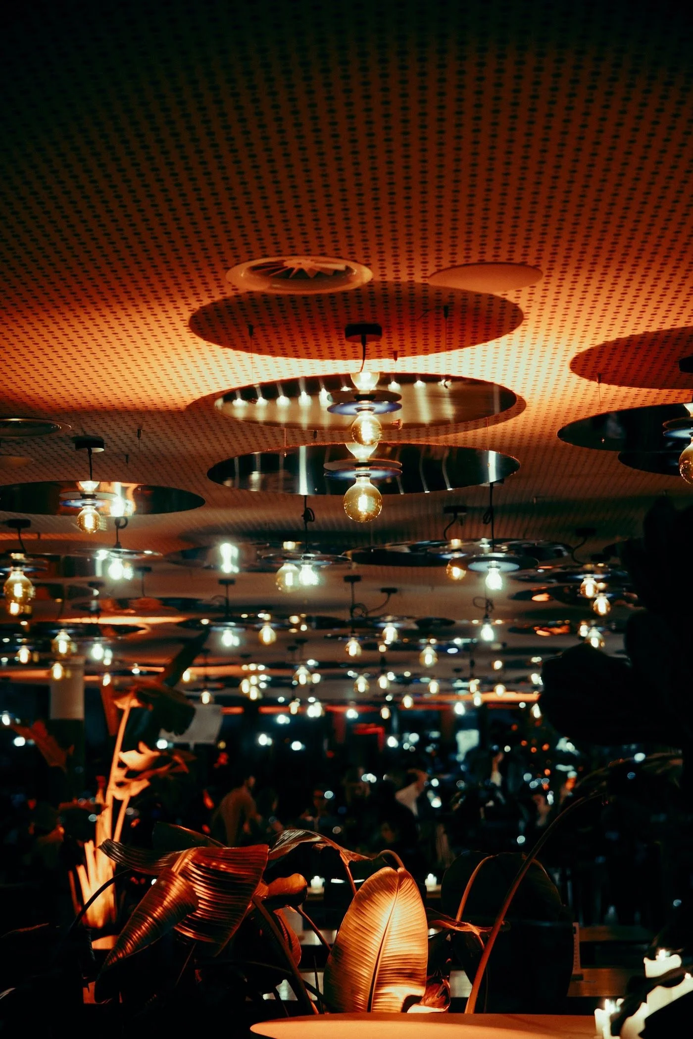 The Penthouse's mirrored ceiling and hanging bulbs above the dining room