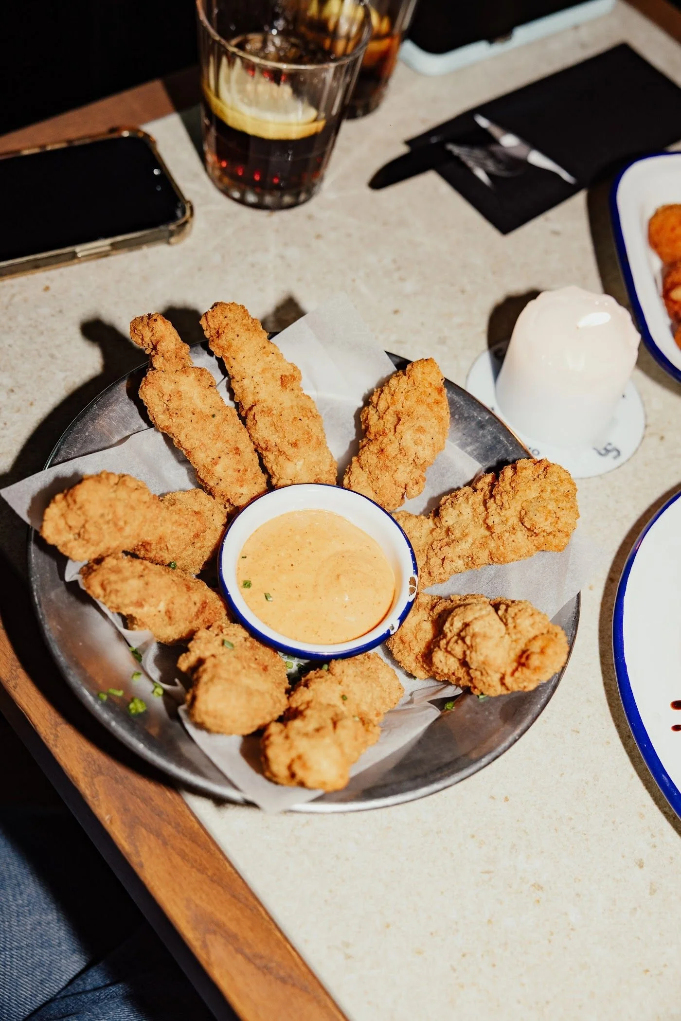 Crispy chicken tenders with a side of dipping sauce
