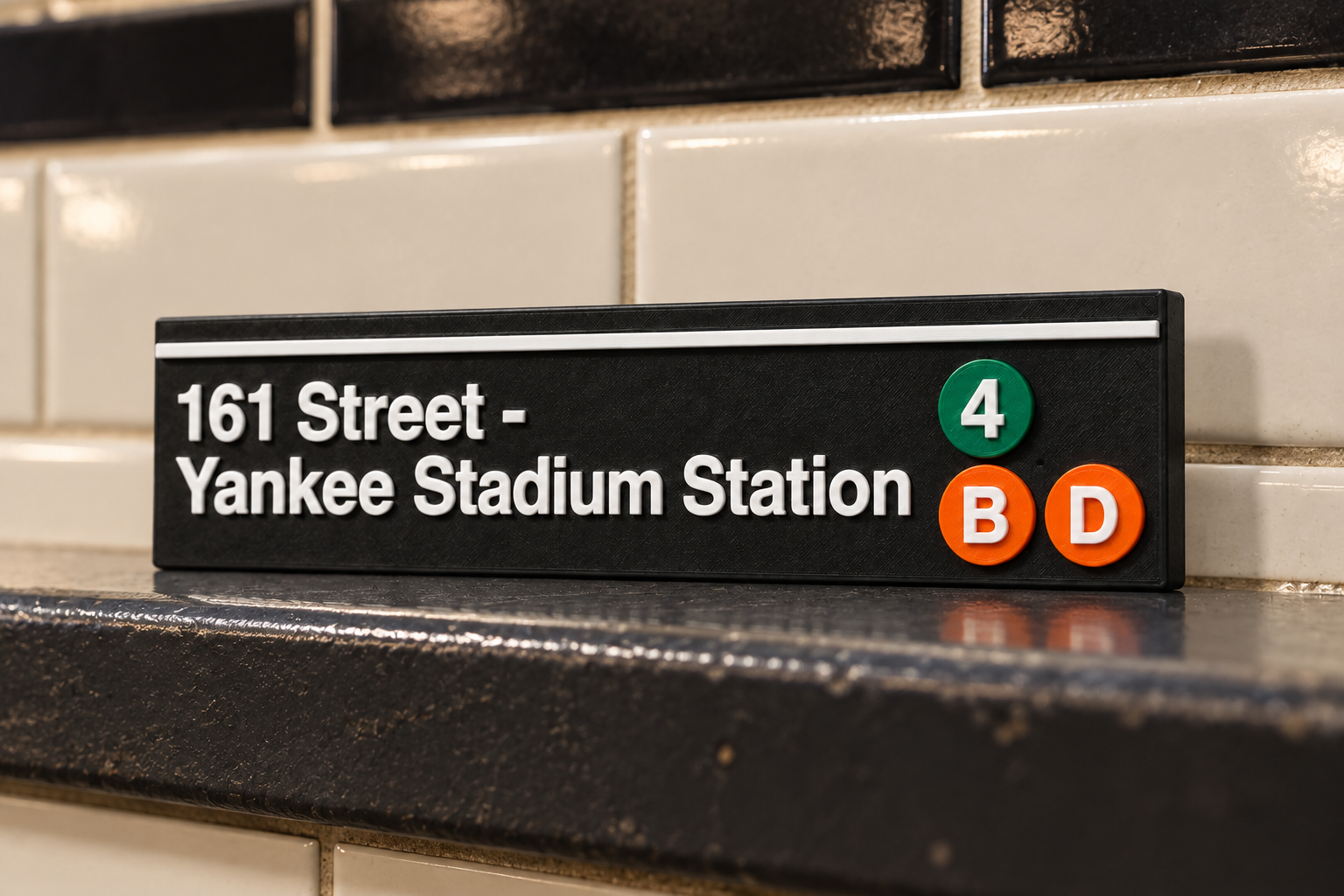 161 Street – Yankee Stadium Station magnet standing on a subway platform ledge against white tile