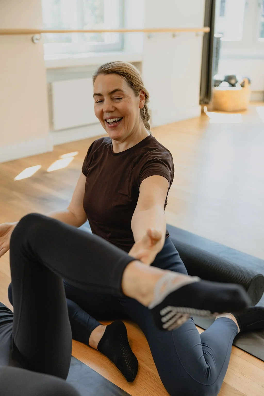 An instructor offering attentive guidance during a private Pilates session