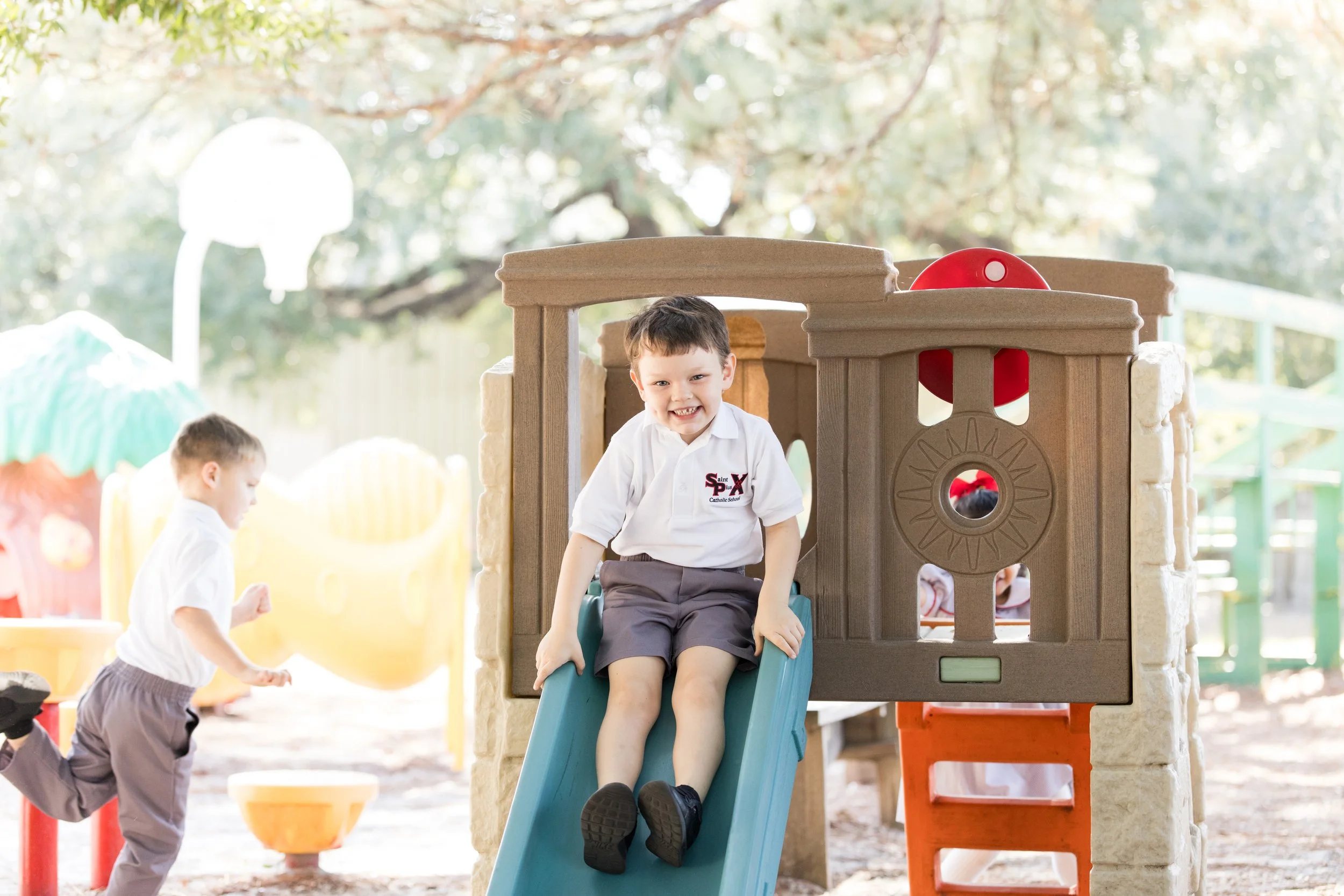 Preschool students enjoying the playground at St. Pius X